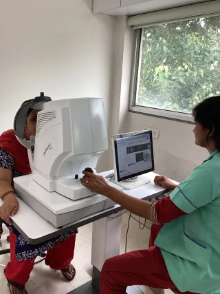 A patient being measured on the Zeiss IOL Master 700