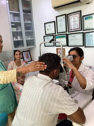 Dr. Shetal Raj examining a patient at the slit lamp